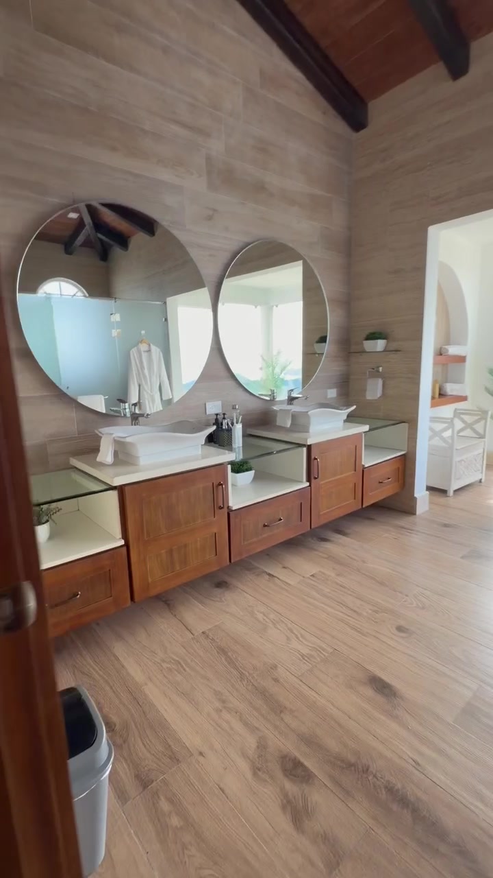 Modern bathroom with dual vanity and round mirrors