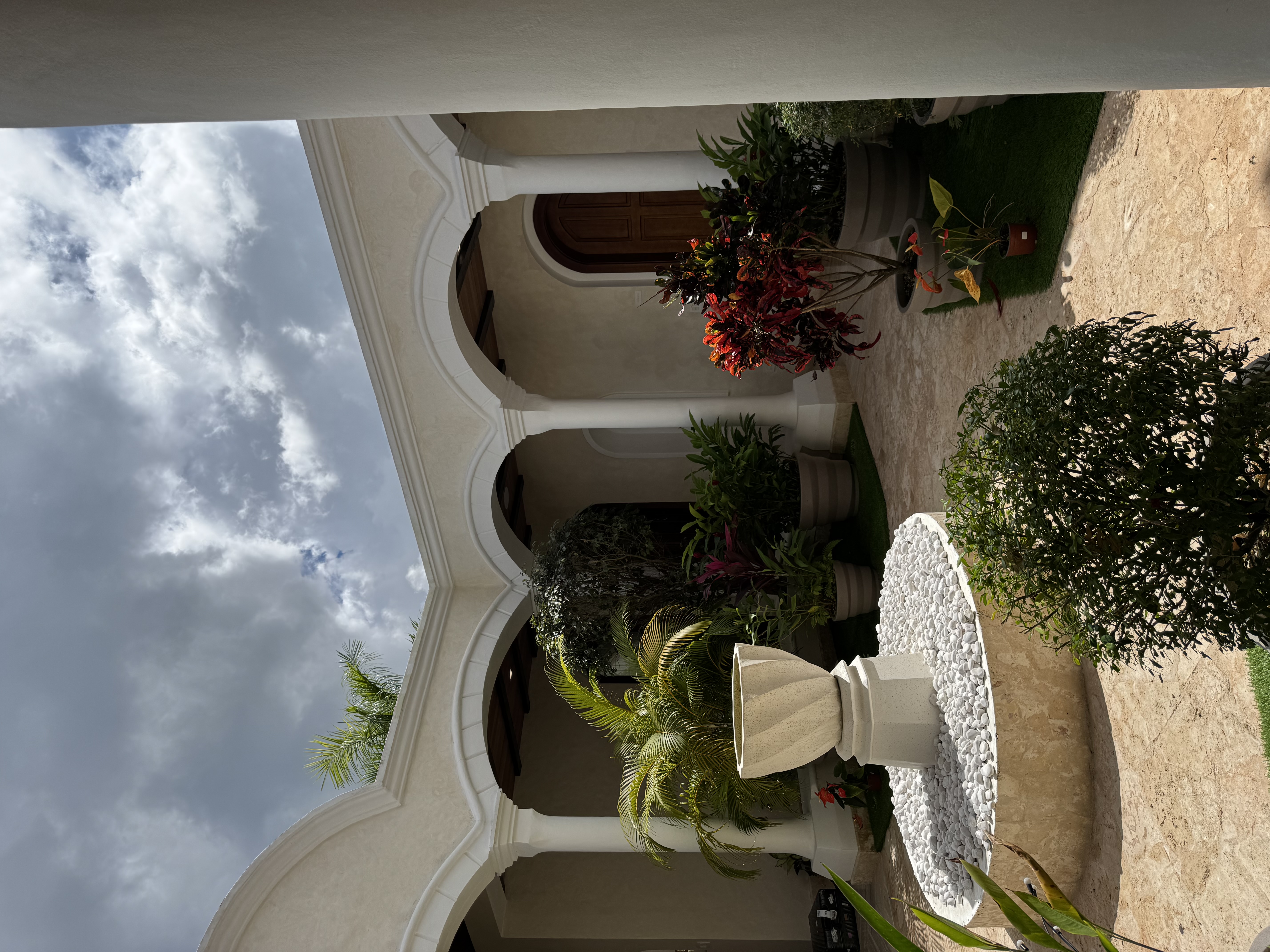 Arched walkways with fountain and tropical plants