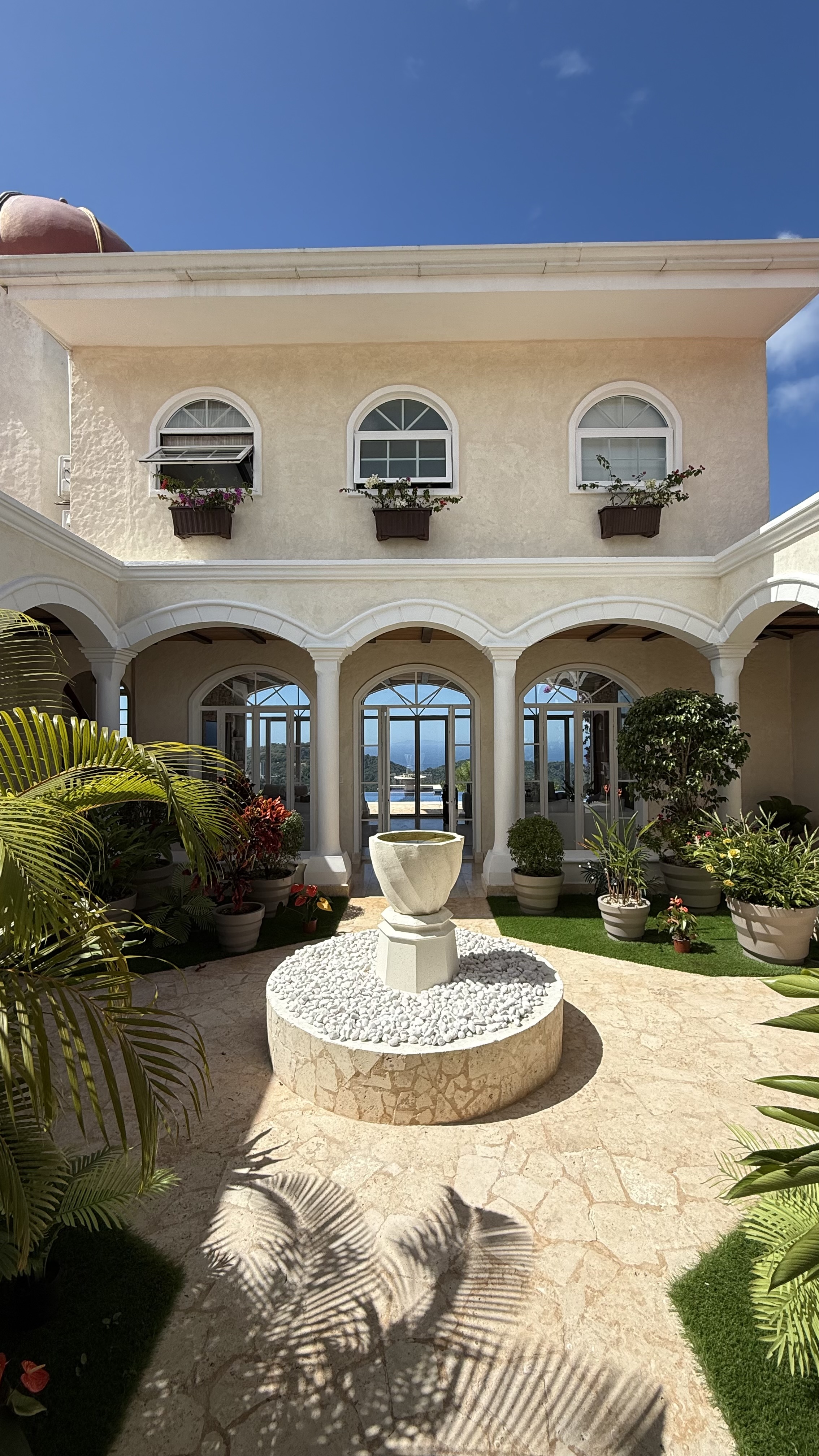 Mediterranean courtyard with fountain and tropical plants