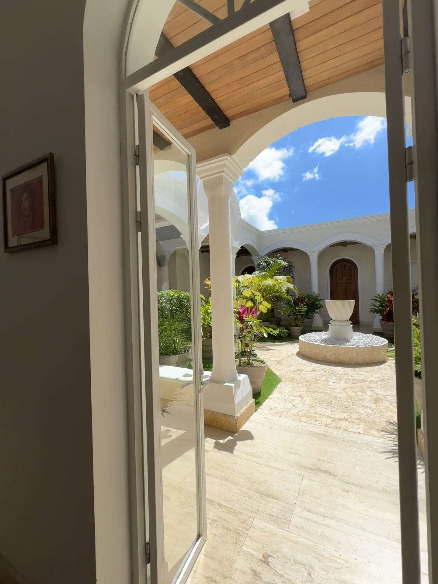 View through archway to courtyard with fountain