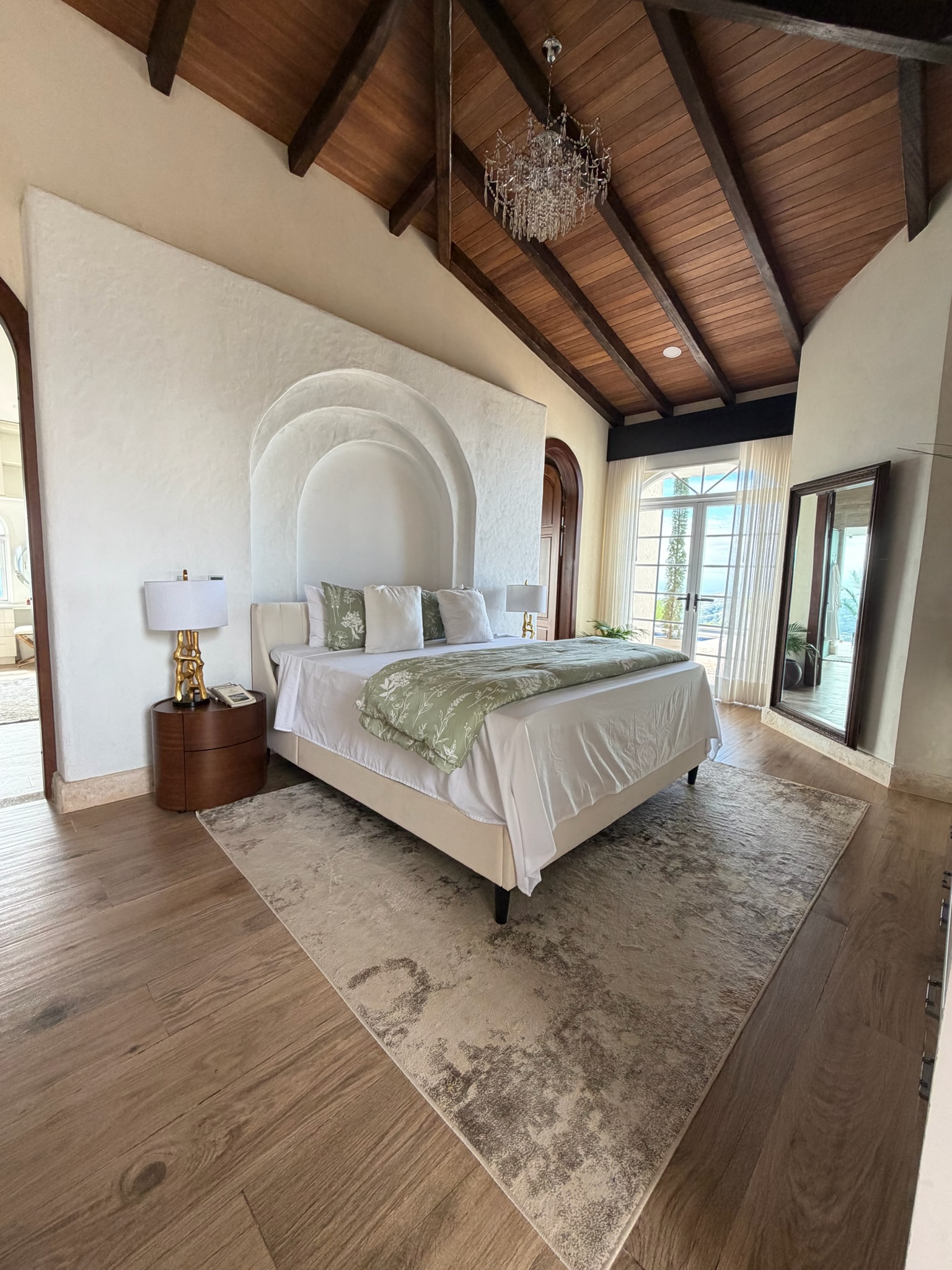 Master bedroom with vaulted wood ceiling and chandelier